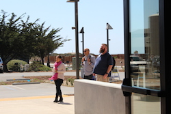 three people walking toward the building entrance